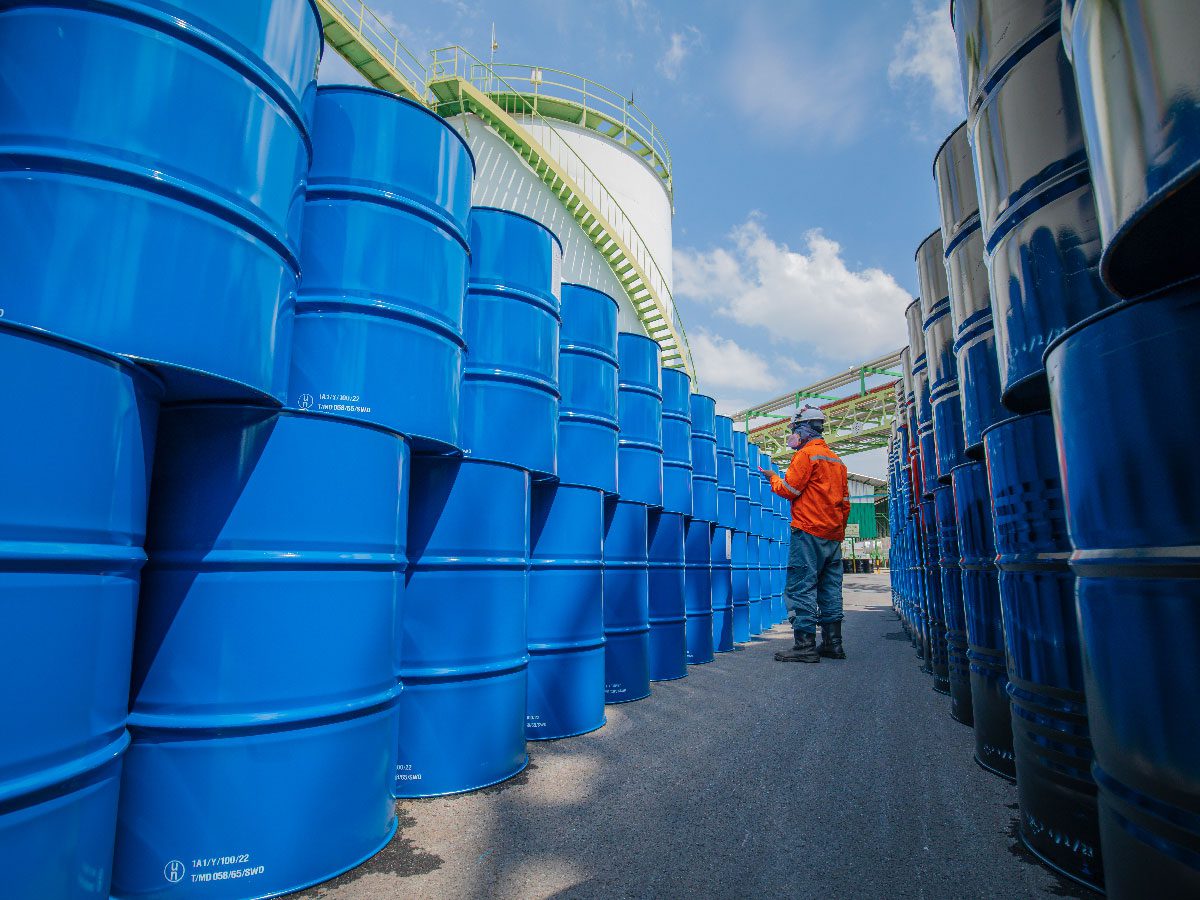 Synsus operations specialist inspecting chemical drums as part of value-added services