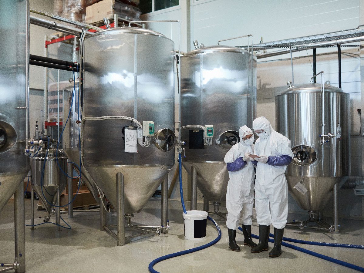 Synsus team members reviewing production data inside a modern manufacturing facility
